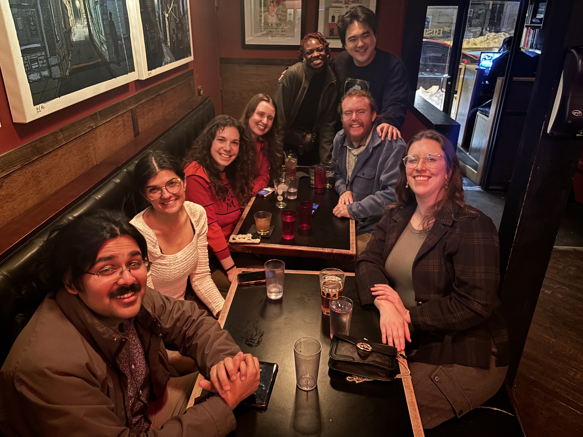 Sara with friends at a bar after Midwest Winter Workshop in 2026