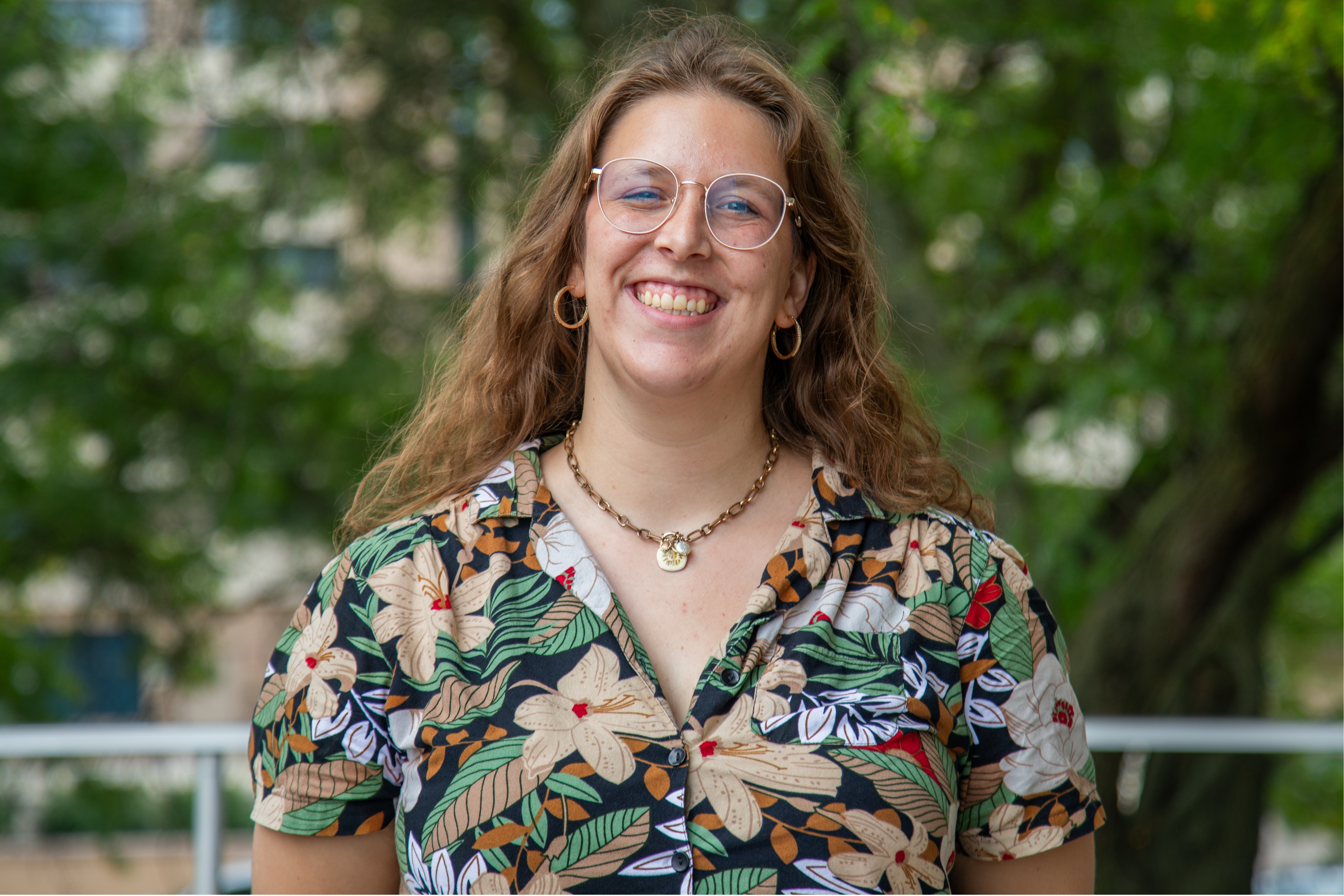 Sara Rabon smiling for a headshot photo on a fall day in Madison
