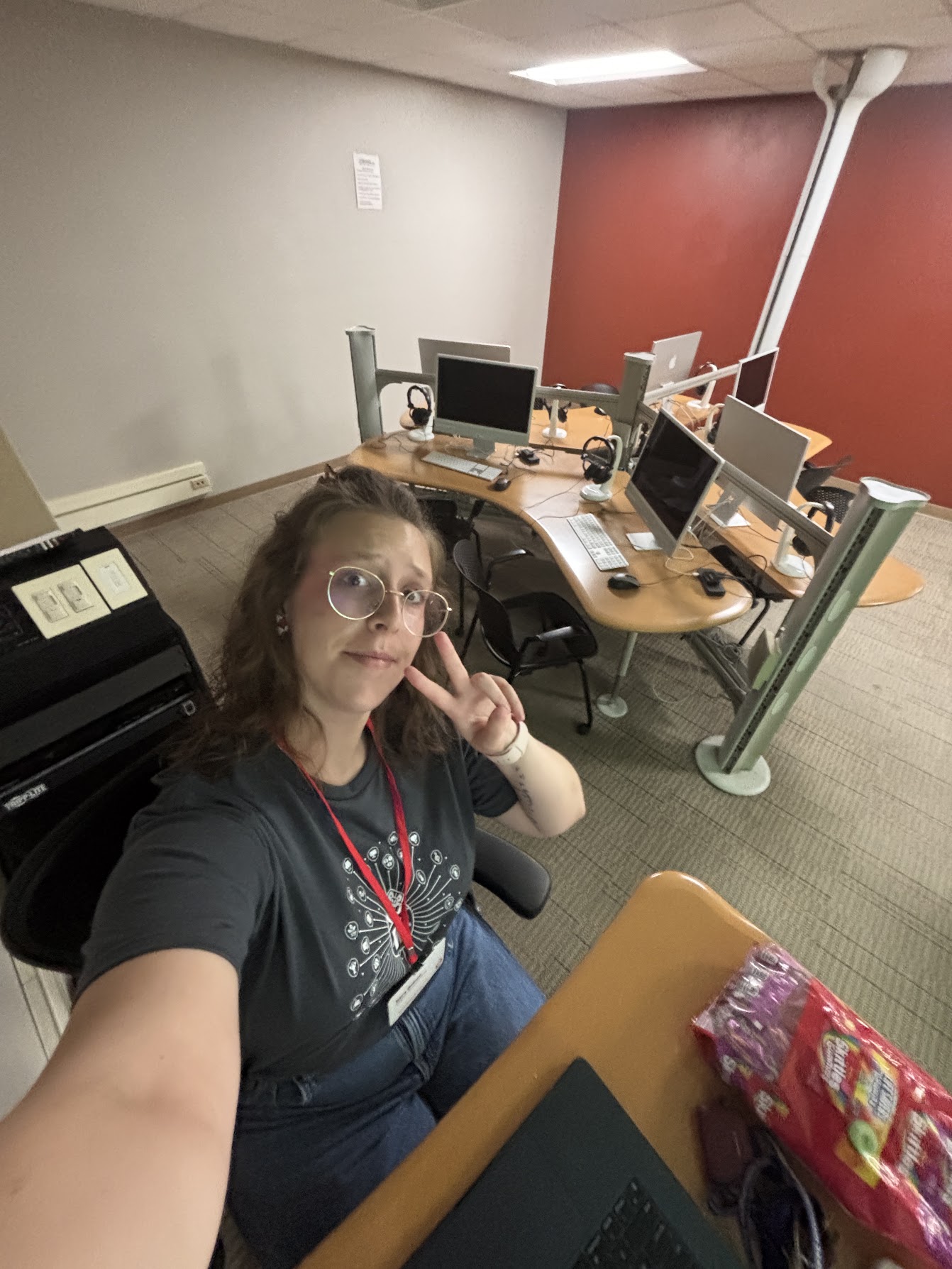 Sara taking a self in the computer lab before teaching, 2025